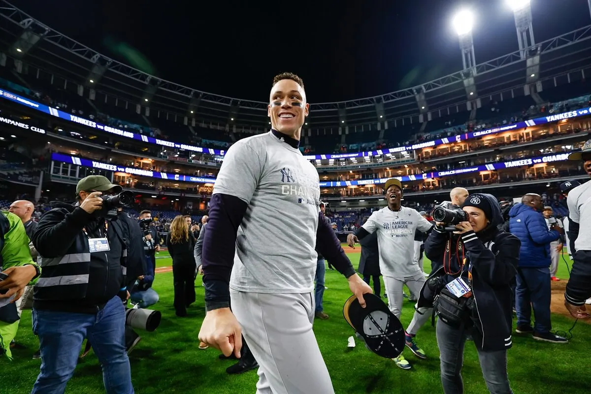 Aaron Judge celebrates on the field after defeating the Cleveland Guardians in Game 5 of the ALCS