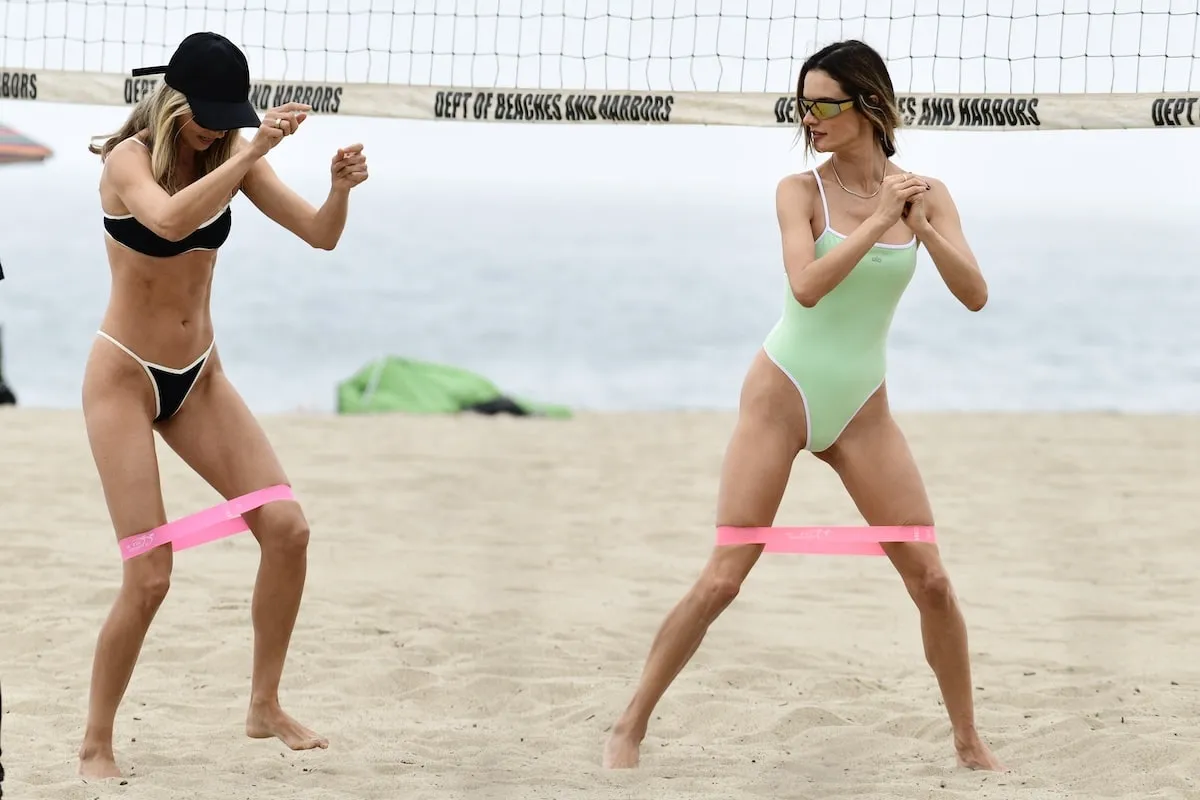 Wearing a mint green one-piece swimsuit, Alessandra Ambrosio plays volleyball and works out at the beach