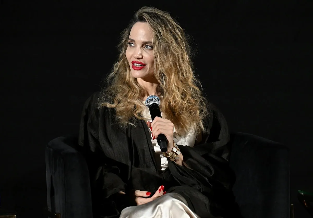 Wearing red lipstick and a curly hairstyle, Angelina Jolie answers a question during the Q&A at the 'Maria' screening at AFI Fest