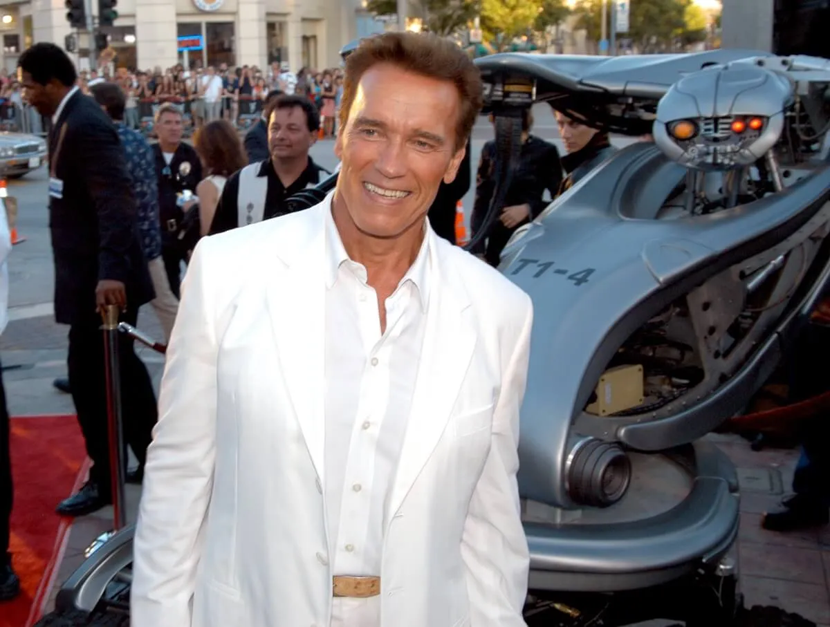 Arnold Schwarzenegger posing in a white suit at the 'Terminator 3' premiere.