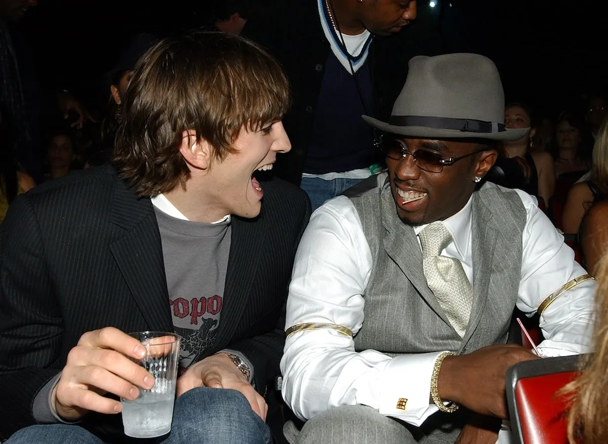 Actor Ashton Kutcher and Sean 'Diddy' Combs laugh together at a VH1 event in 2003