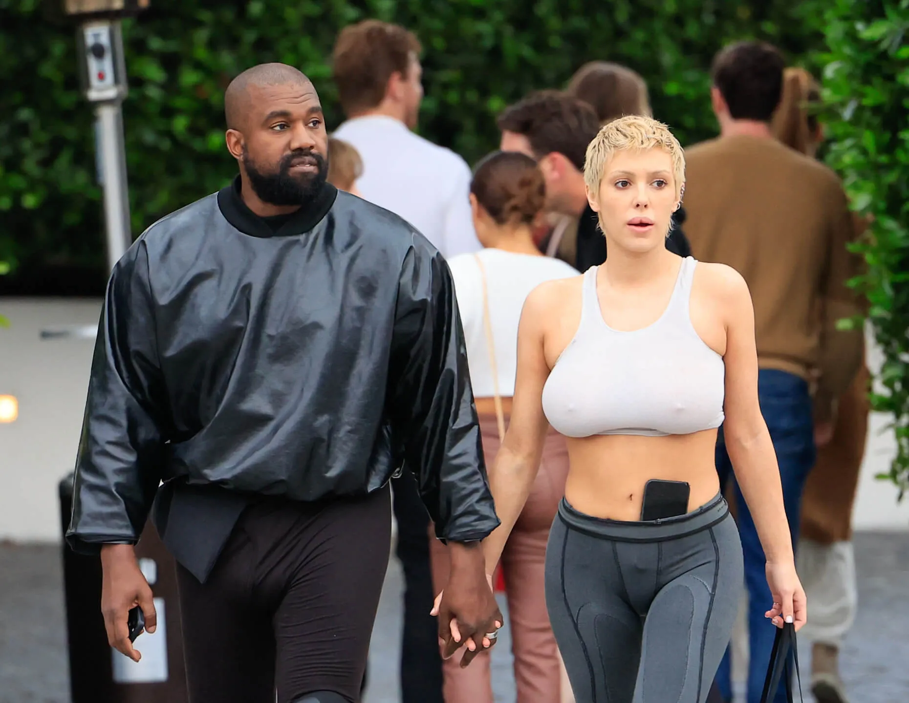 Bianca Censori and Kanye West walking hand in hand in Los Angeles