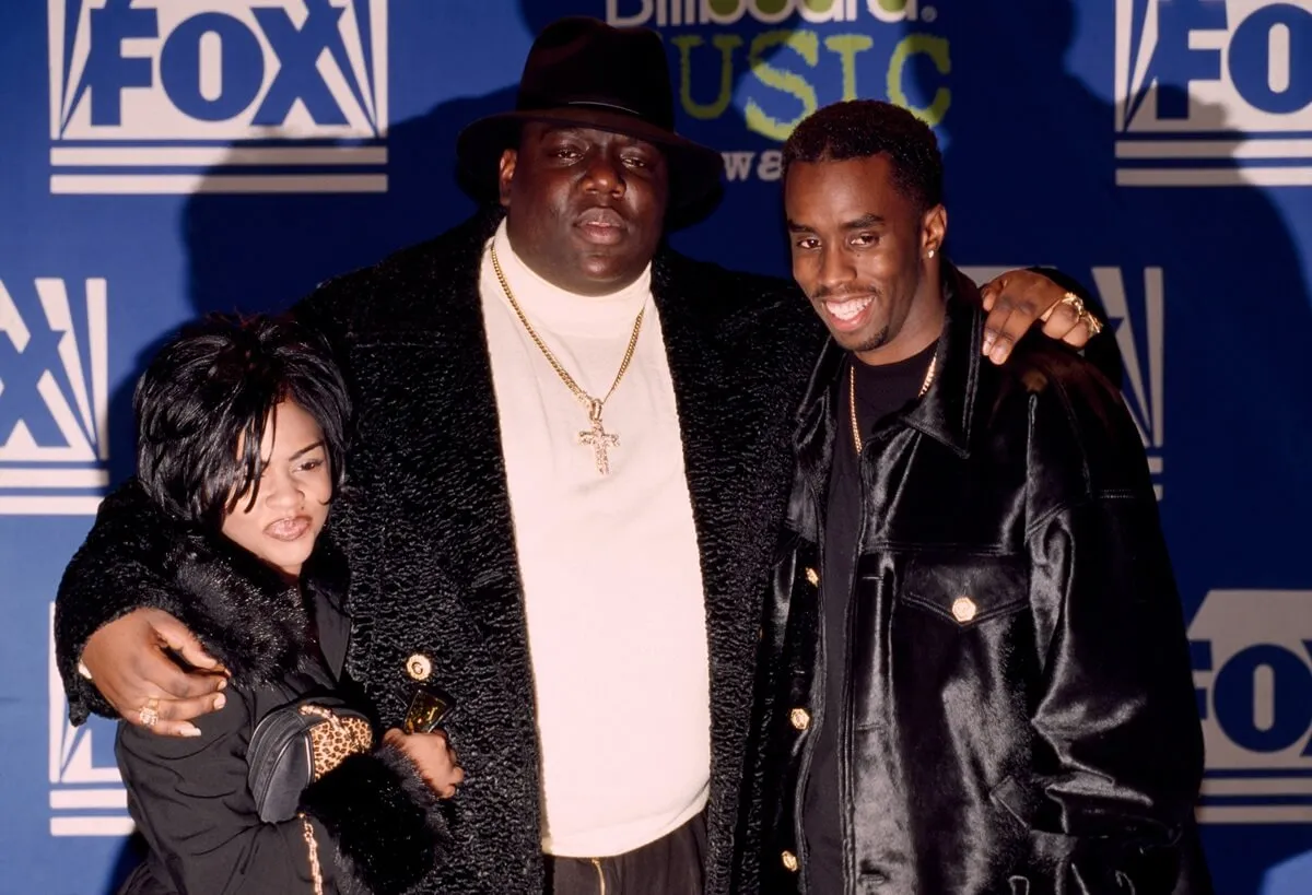 Biggie Smalls posing alongside Sean 'Diddy' Combs and Lil' Kim at the Billboard Music Awards.