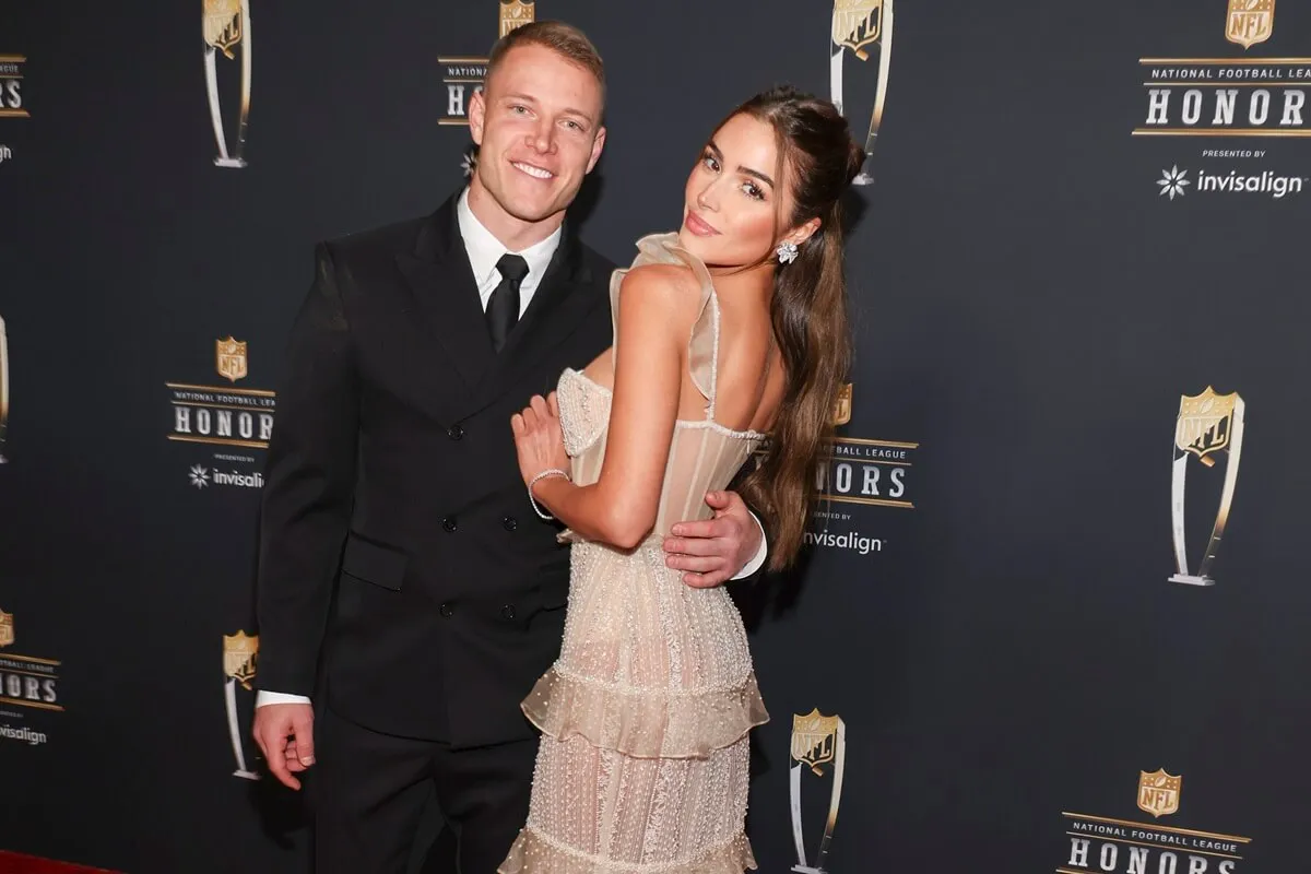 Christian McCaffrey and Olivia Culpo pose on the carpet at The 12th Annual NFL Honors