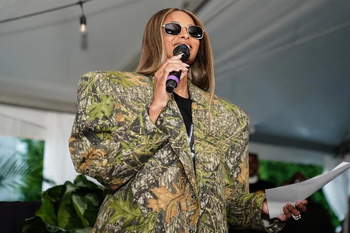 Wearing an oversized camouflage suit, Ciara speaks at a VIP Reception before a When We All Vote rally in Georgia