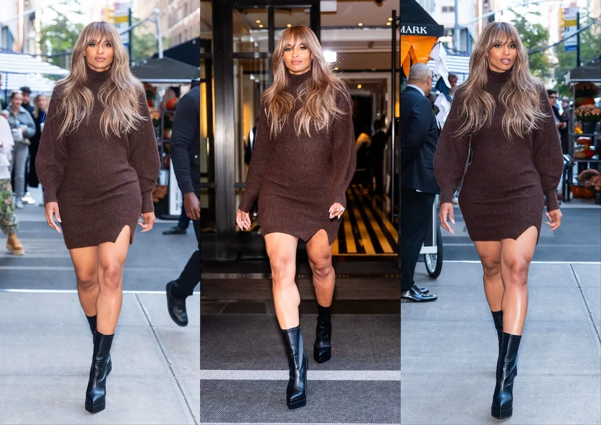 Singer Ciara wears a chocolate brown sweater dress and smiles at the camera as she walks down an NYC street