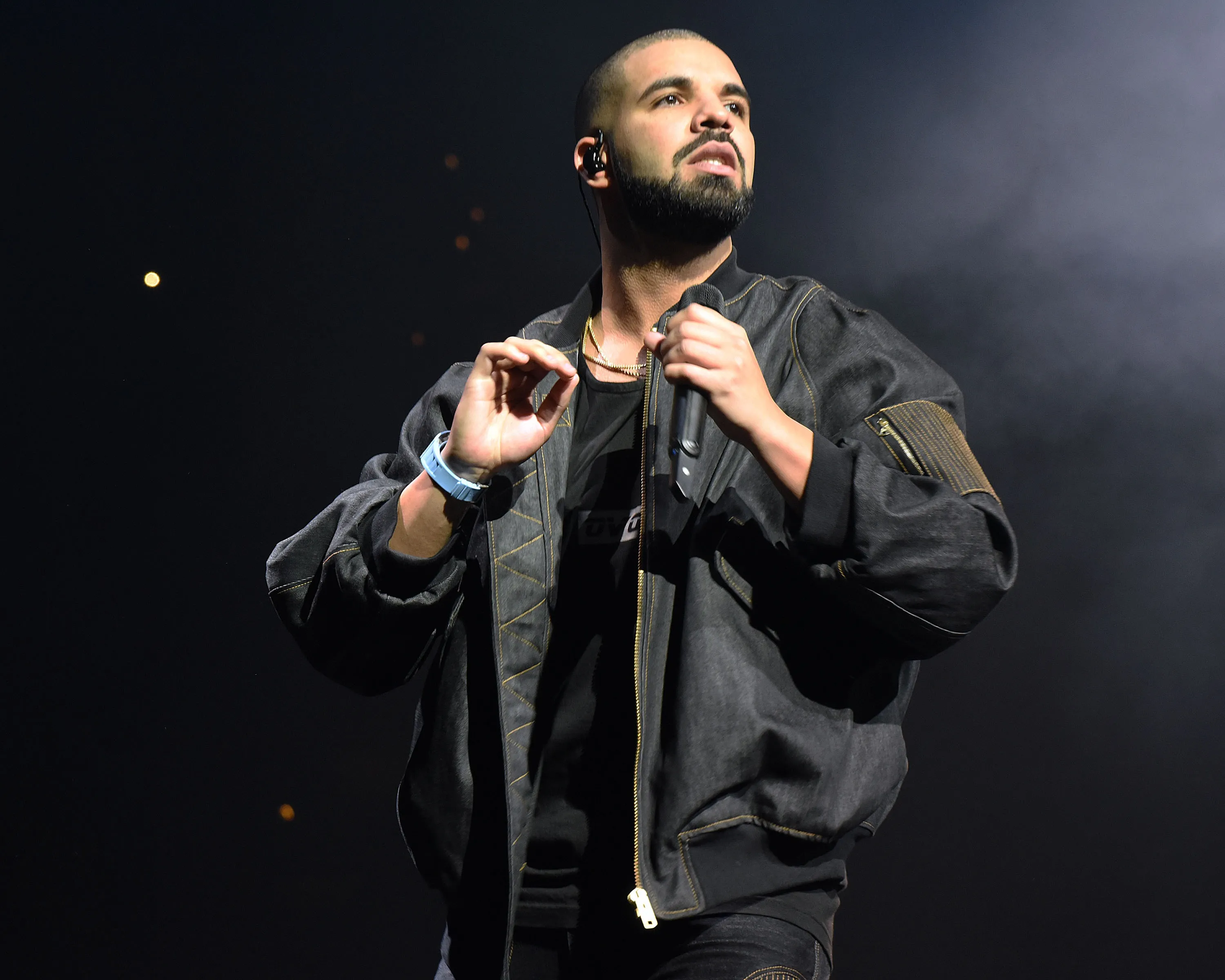 Drake on stage against a dark background in 2016