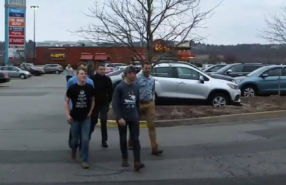 The Duggar boys walk through a parking lot together