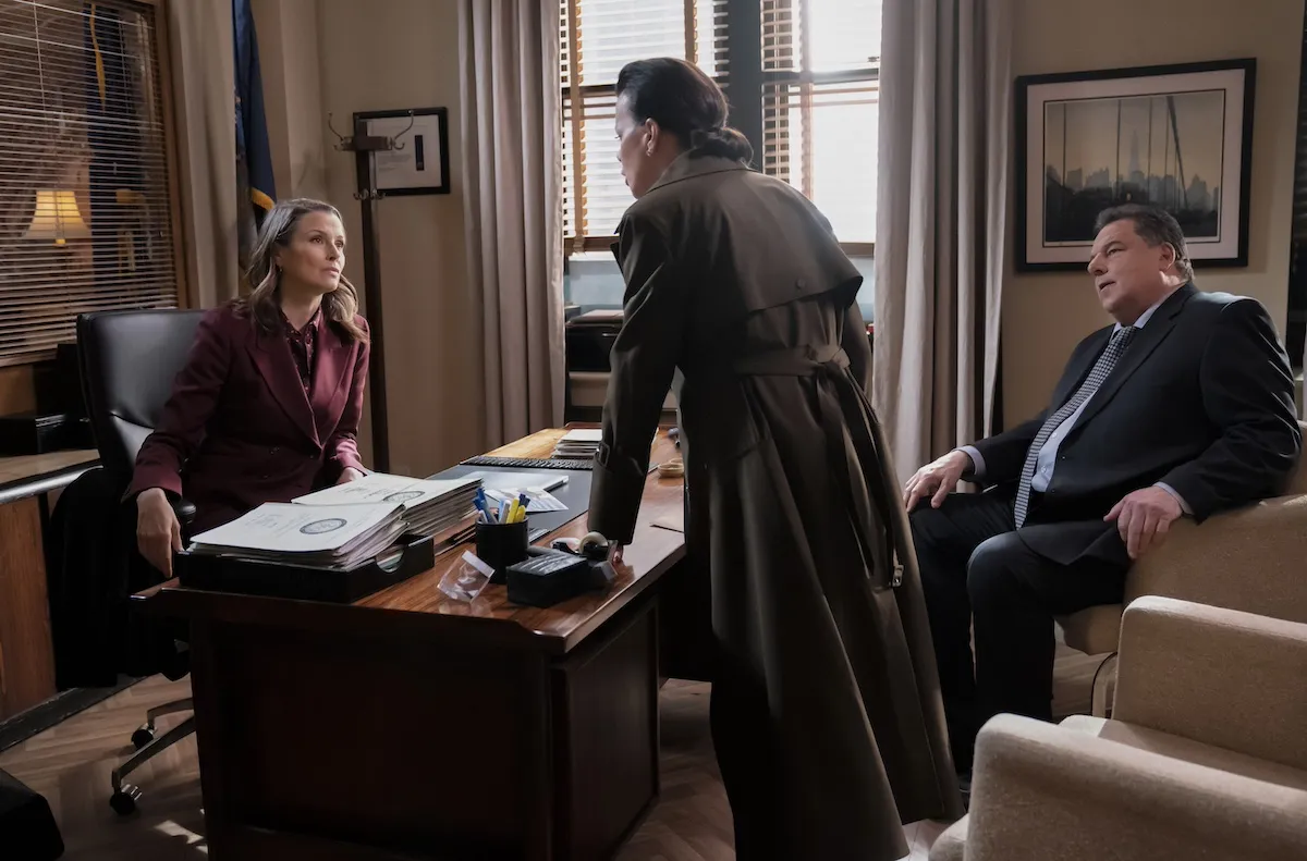 Erin Reagan (Bridget Moynahan) sitting behind a desk and talking to two people