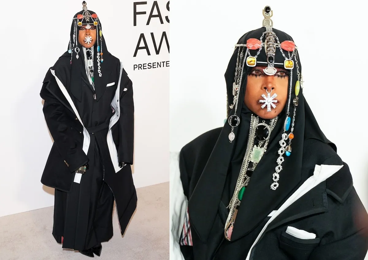 Wearing a black coat, dress, and headpiece, Erykah Badu poses for photos at the CFDA Fashion Awards 2024