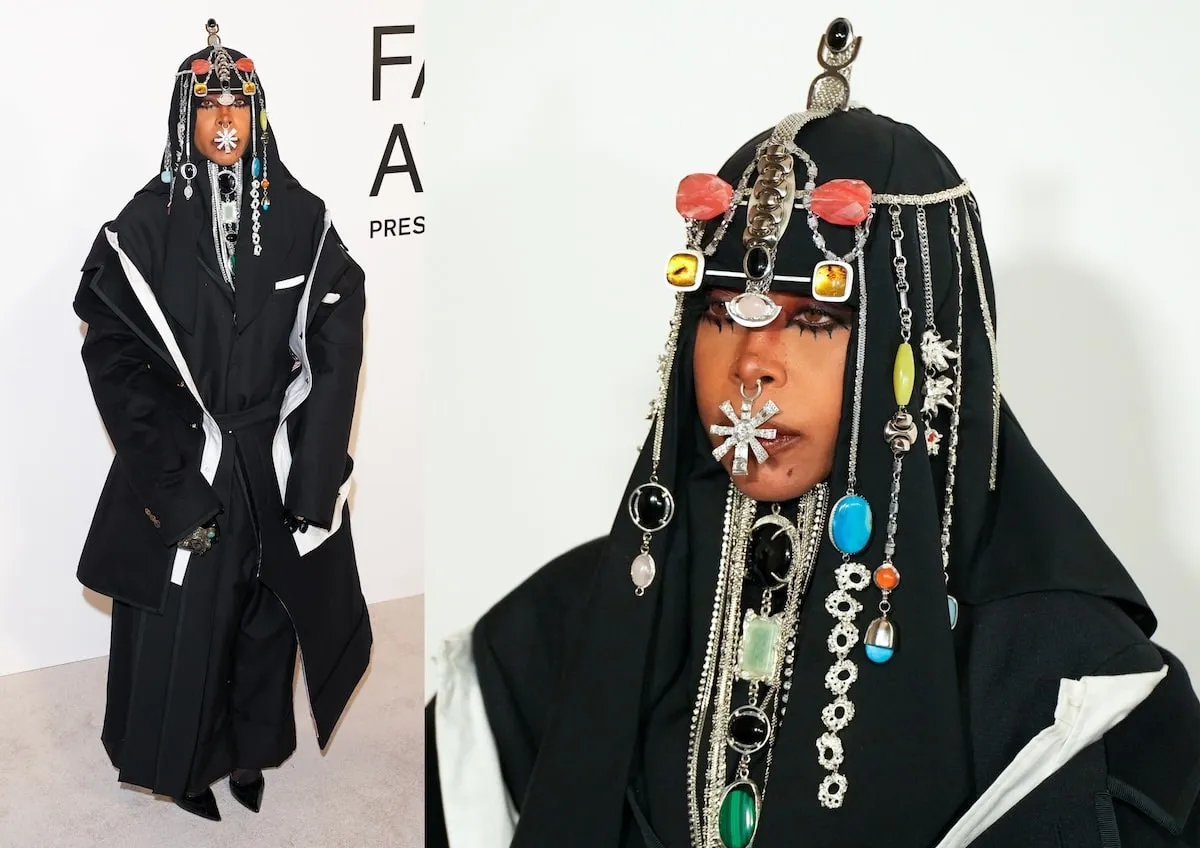 Wearing a black coat, dress, and headpiece, Erykah Badu poses for photos at the CFDA Fashion Awards 2024