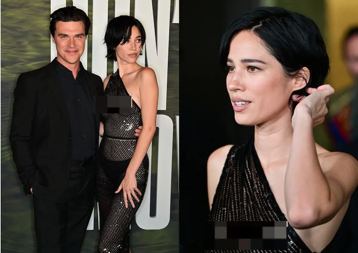 Wearing a black sheer dress, Kelsey Asbille smiles with Finn Wittrock on the red carpet of the Don't Move photo call