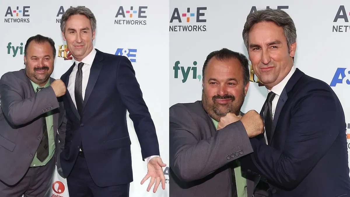 American Pickers stars Frank Fritz and Mike Wolfe hold their fists up to each other on the red carpet