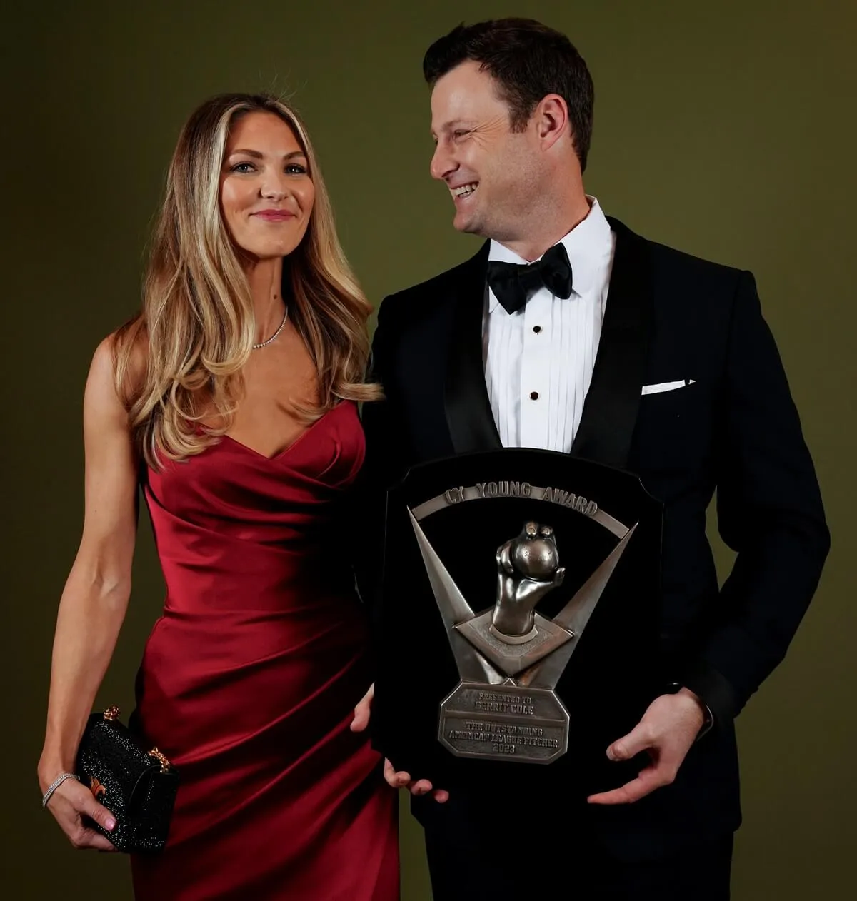 Gerrit Cole poses for a portrait with his wife, Amy, while holding his CY Young Award