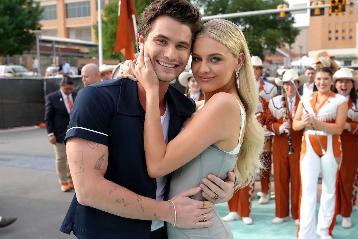 Chase Stokes and Kelsea Ballerini, whose relationship rule is British royal family coded, smile.