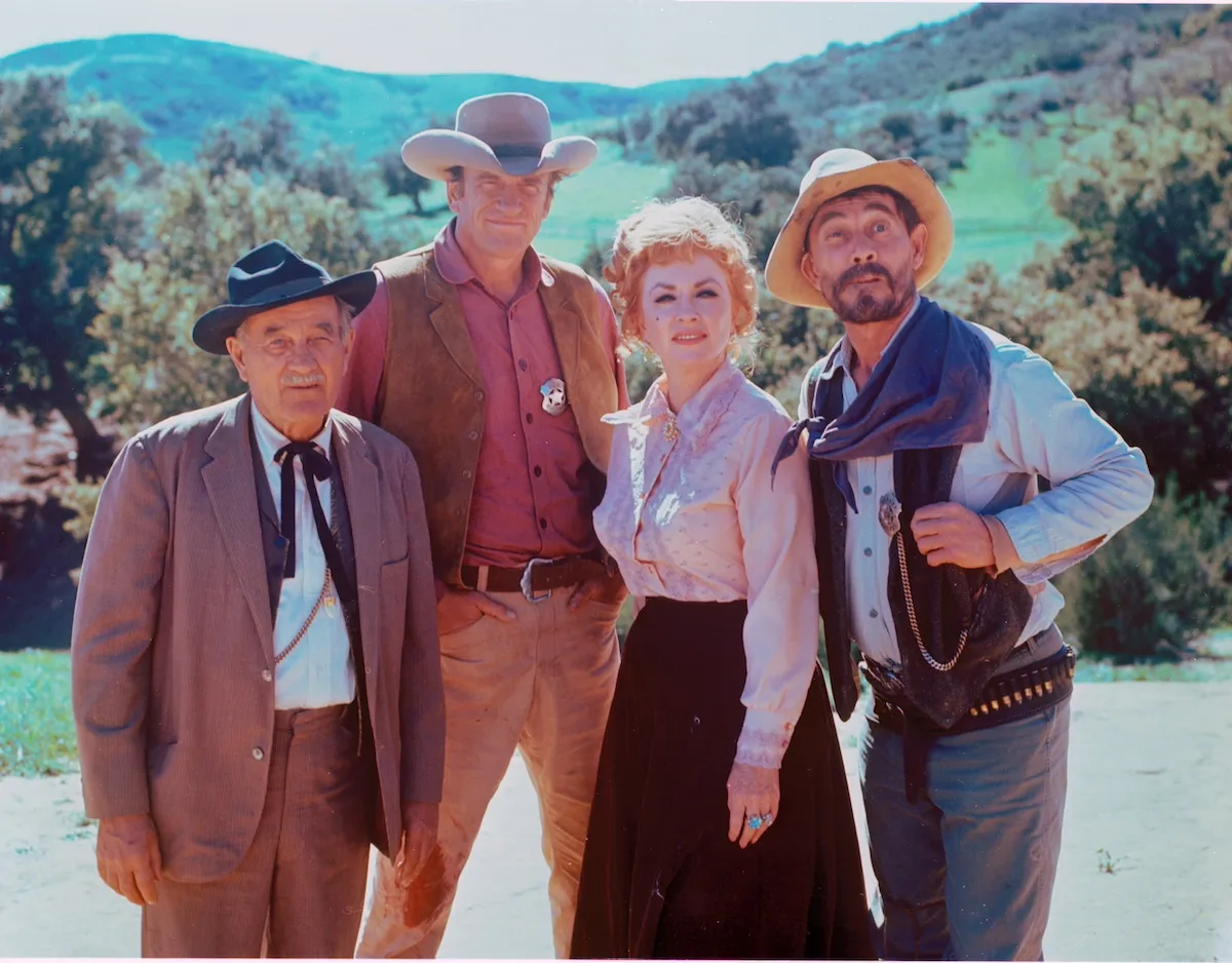 Color photo of the cast of 'Gunsmoke' in costume