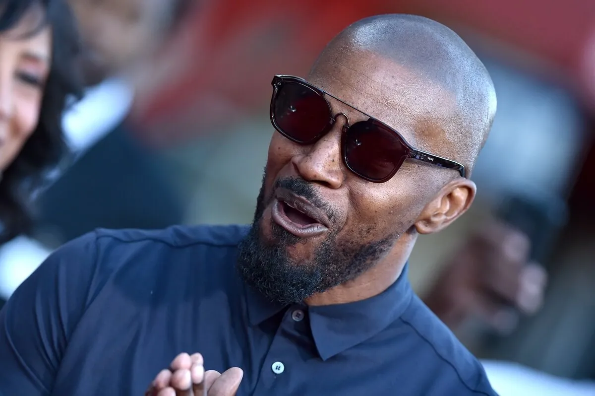 Jamie Foxx attends the LA Premiere of Entertainment Studios' "47 Meters Down Uncaged" while wearing sunglasses and a blue shirt.