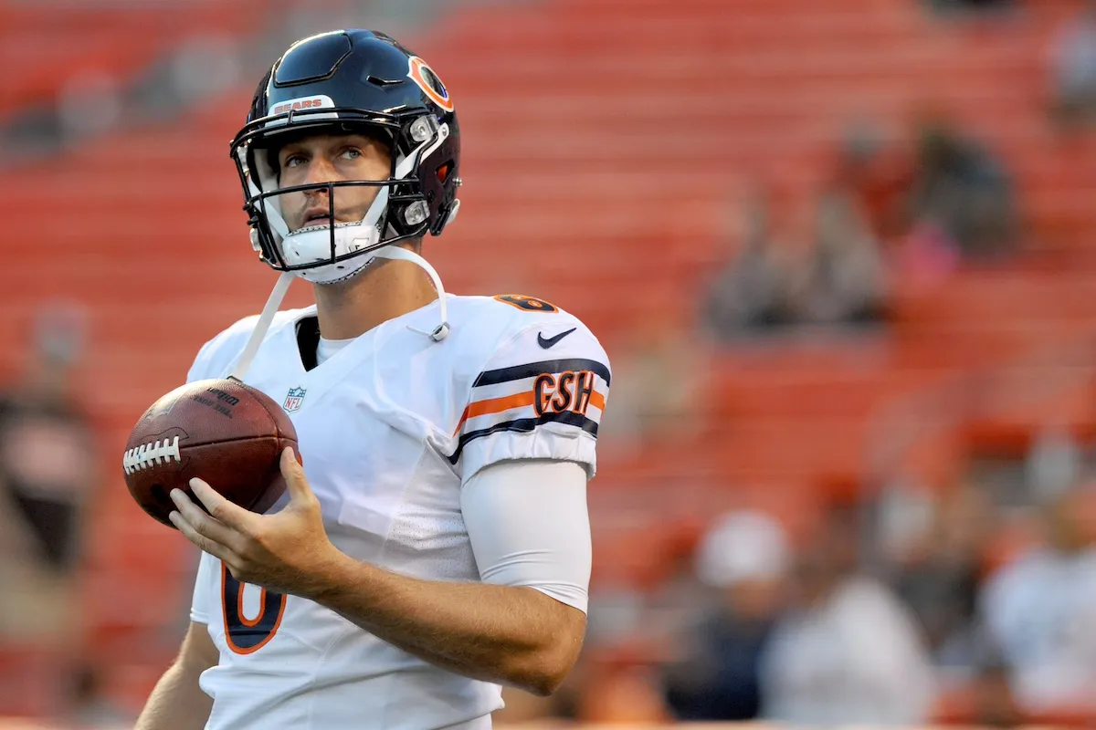 Jay Cutler wearing a helmet and holding a football in Chicago Bears uniform