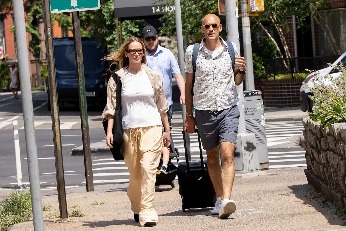 Wearing a white tee shirt and yellow pants, Jennifer Lawrence walks with a friend in NYC