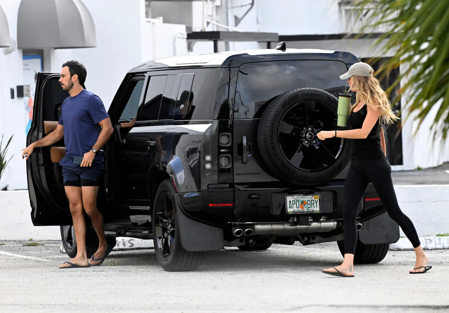 Joaquim Valente and Gisele Bündchen walking to a pilates class after getting out of a black vehicle