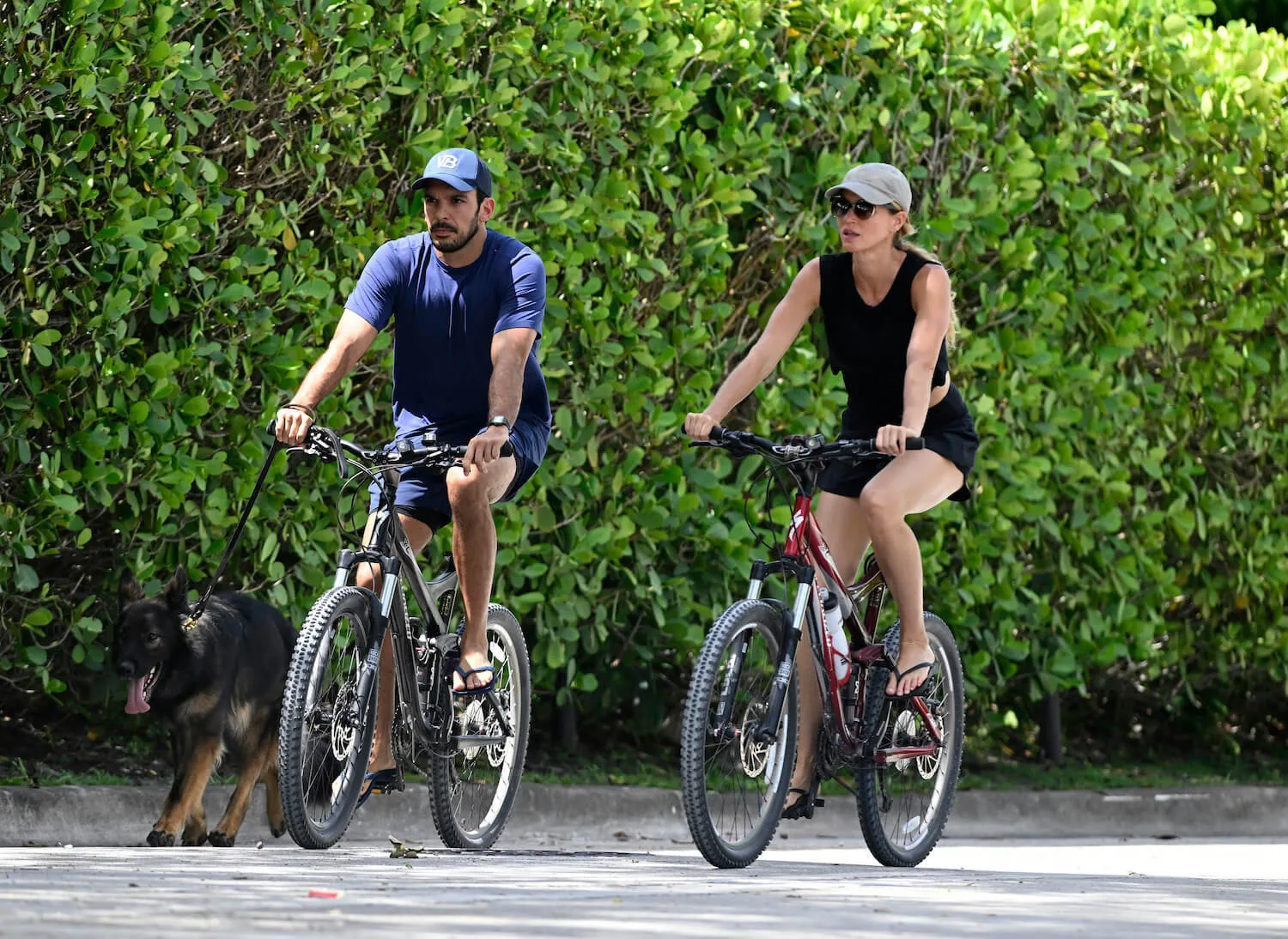 Joaquim Valente and Gisele Bündchen riding bikes next to each other in Florida