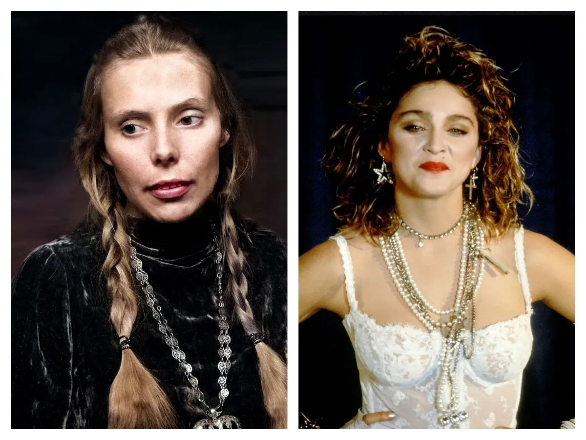 Joni Mitchell wears a black turtleneck and a silver necklace. Her hair is in two braids. Madonna wears a white bustier and many necklaces. She stands with her hands on her hips.