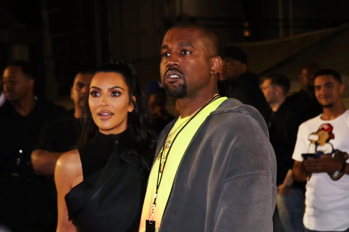 Kanye West and Kim Kardashian posing at the Nas "Nasir" Album Listening Session.