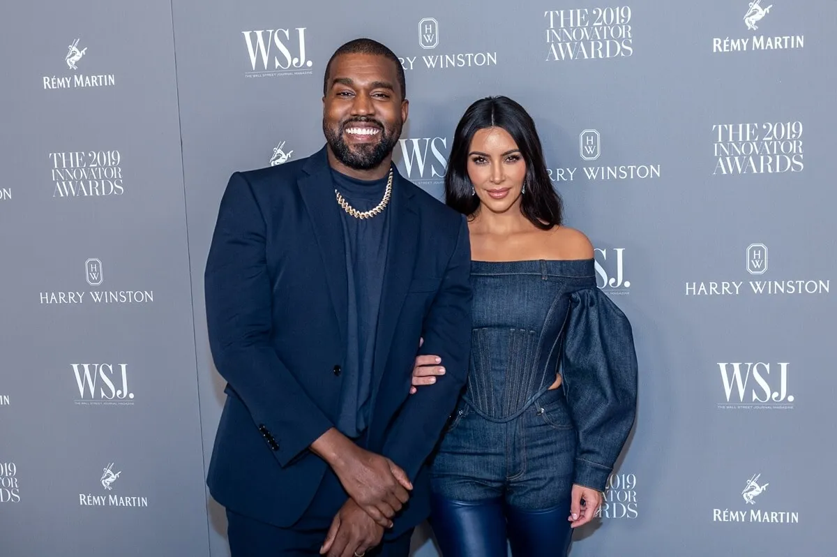 Kanye West and Kim Kardashian posing at the WSJ Mag 2019 Innovator Awards in matching-colored outfits.