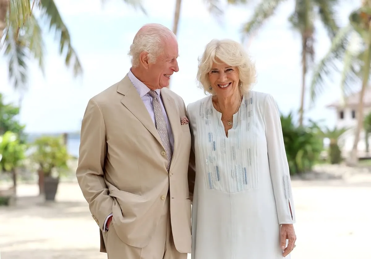 King Charles III and Queen Camilla smile during a visit to a beach in Apia, Samoa