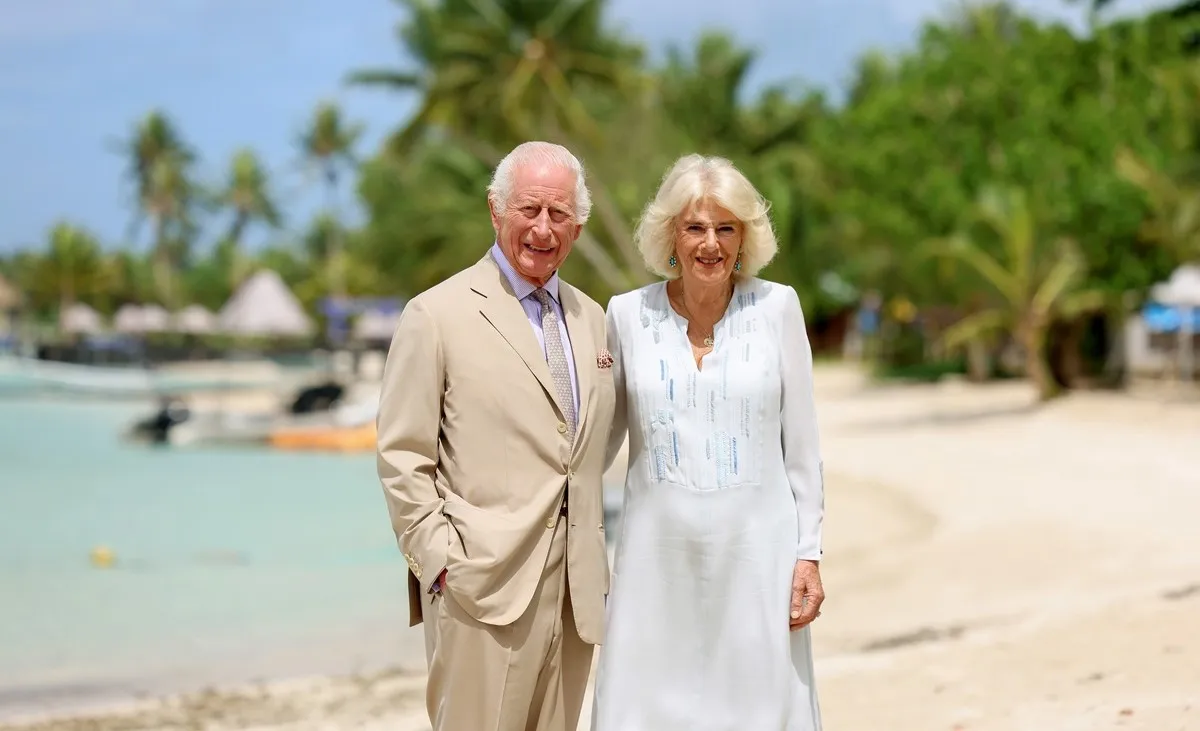 King Charles III and Queen Camilla smile during a visit to a beach in Apia, Samoa