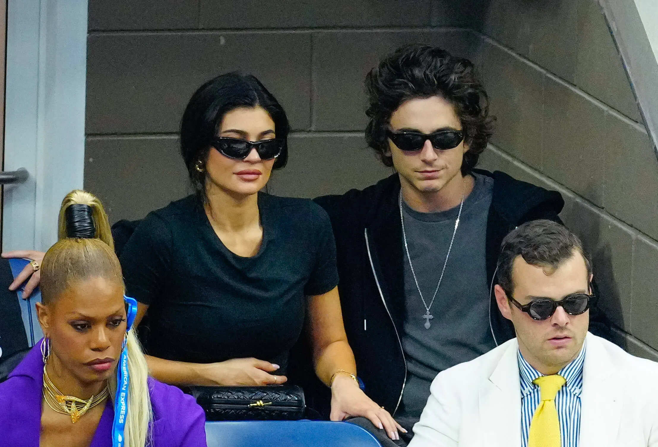 Kylie Jenner and Timothée Chalamet wearing sunglasses and sitting next to each other at the US Open Tennis Championships