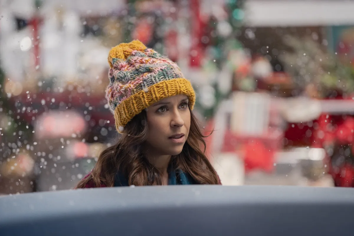 Lacey Chabert wearing a knit hat in the Netflix movie 'Hot Frosty'