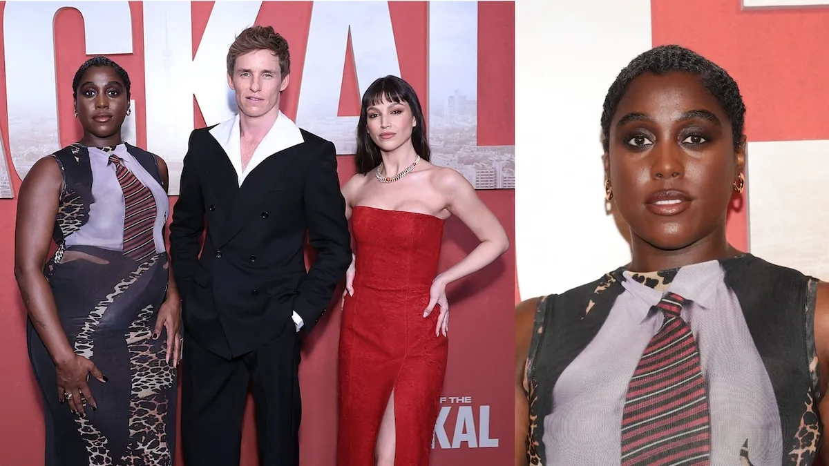 Wearing a black tux, Eddie Redmayne smiles with Lashana Lynch and Ursula Corbero on the red carpet for The Day of the Jackal