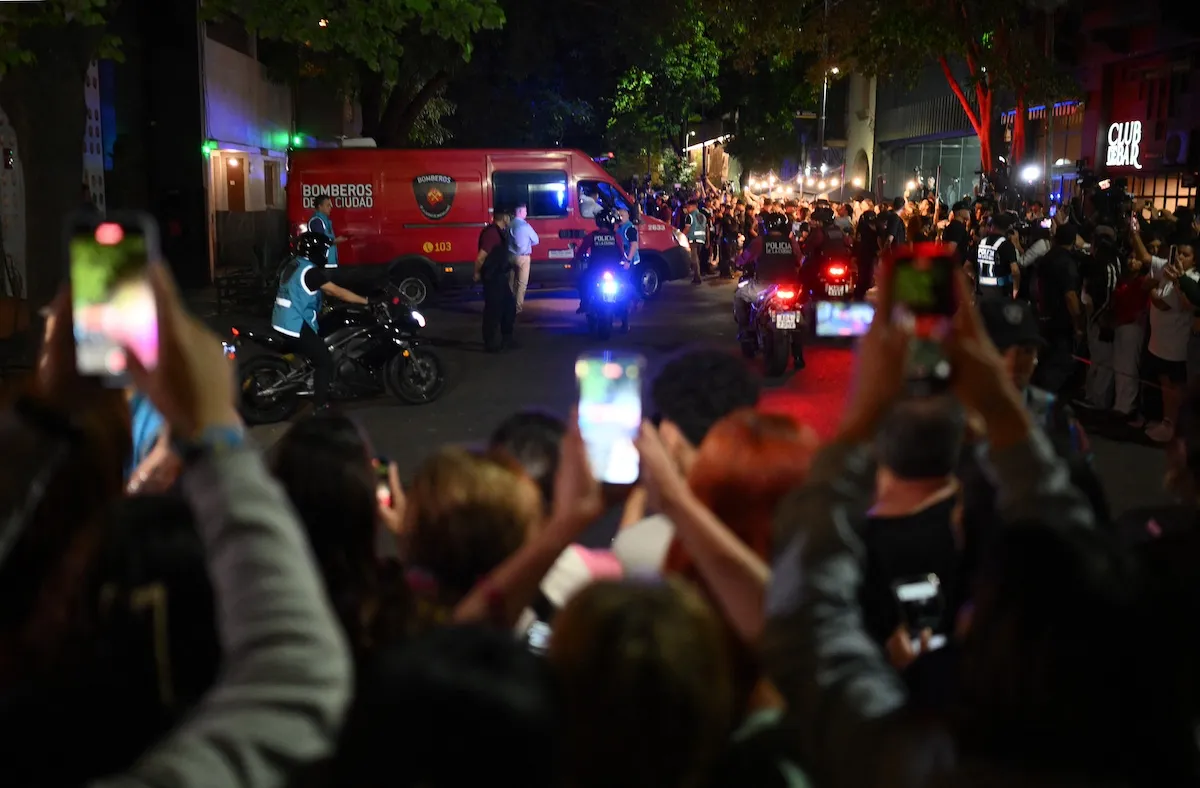 People record an ambulance outside the Casa Sur hotel in Buenos Aires