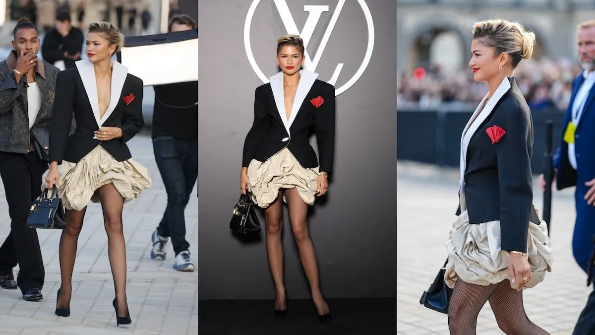 Wearing a black blazer and beige bubble skirt, Zendaya smiles for cameras and walks across the plaza before the Louis Vuitton show