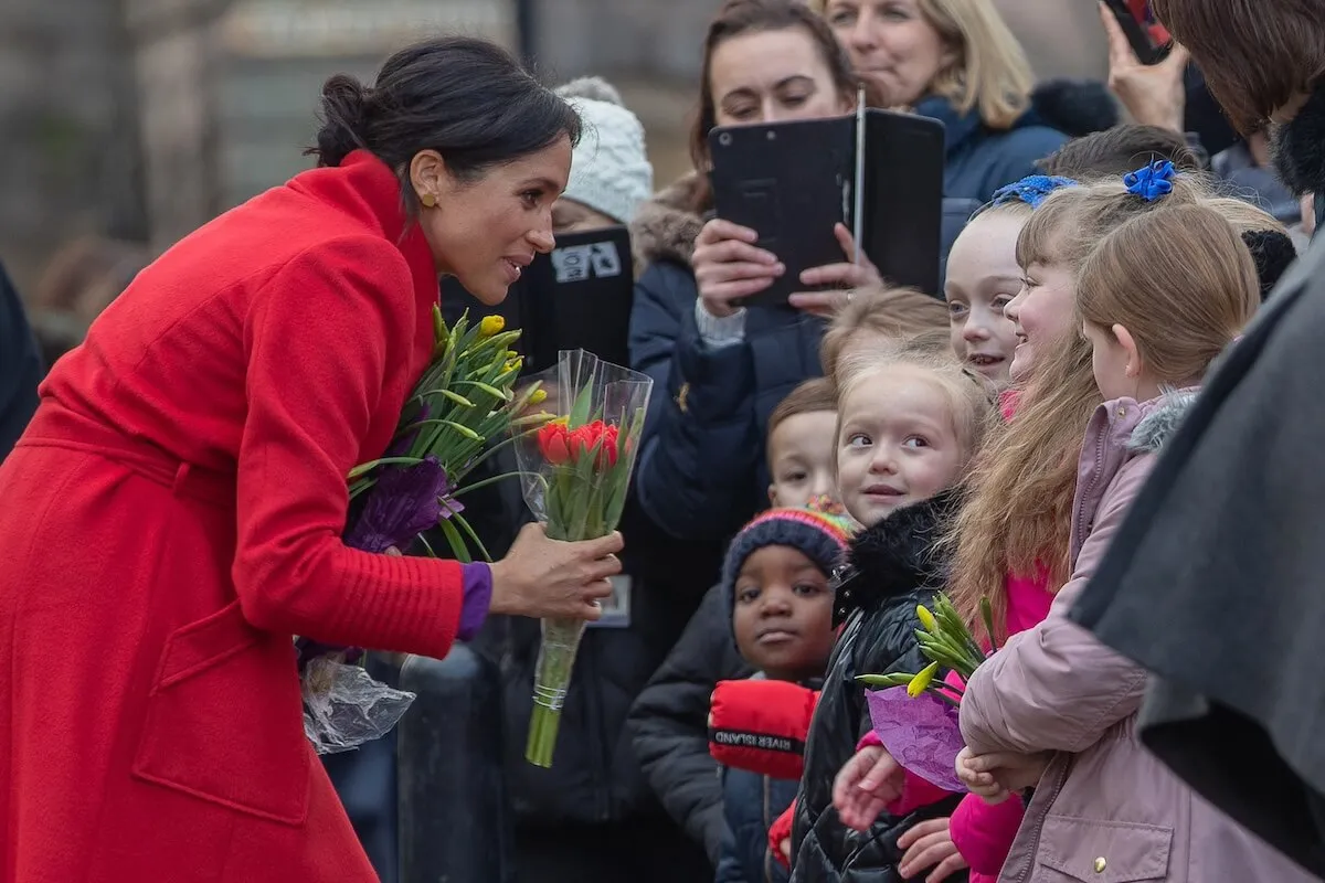 Meghan Markle greets children during a royal walkabout in 2019