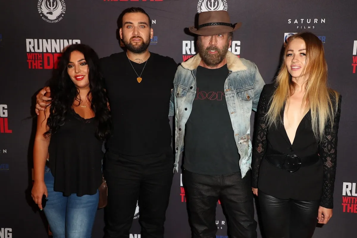 Wearing a jean jacket and full beard, Nicolas Cage stands with his son, Weston, and then-wife Erika Koike in 2019