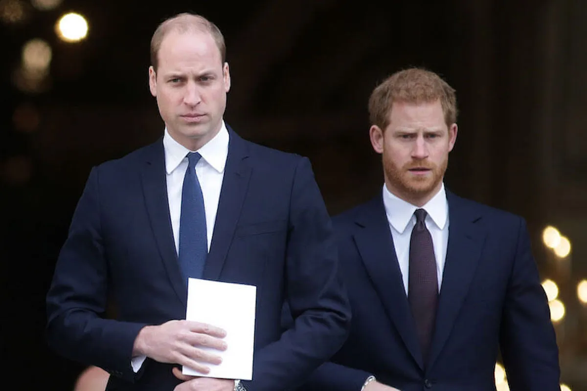 Prince William walks in front of Prince Harry