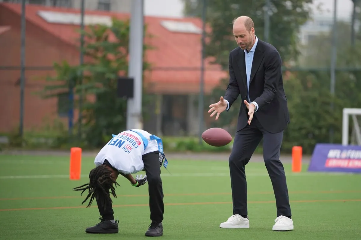 Prince William catches the football as he attends a NFL Foundation Flag event