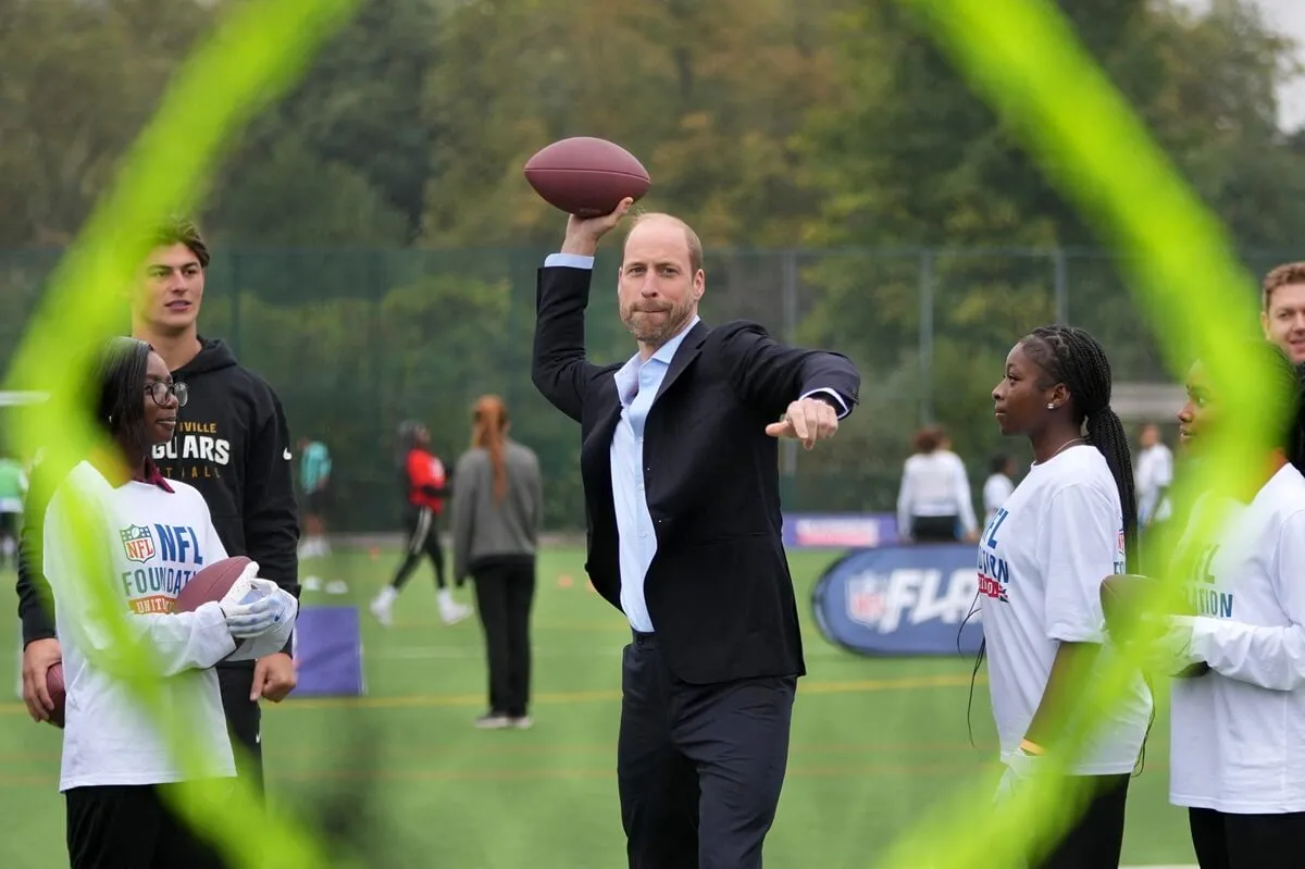 Prince William throws a football as he attends an NFL Foundation event in London