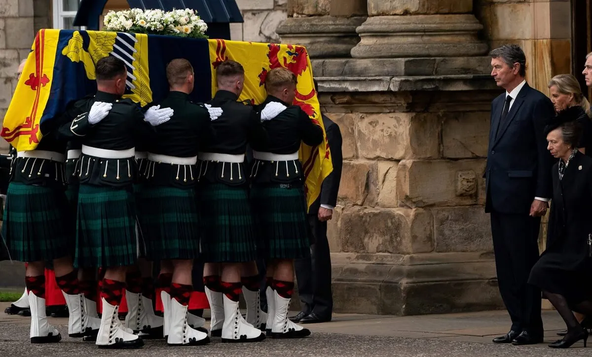 Princess Anne next to her husband, Timothy Laurence, as she curtsies to Queen Elizabeth's coffin