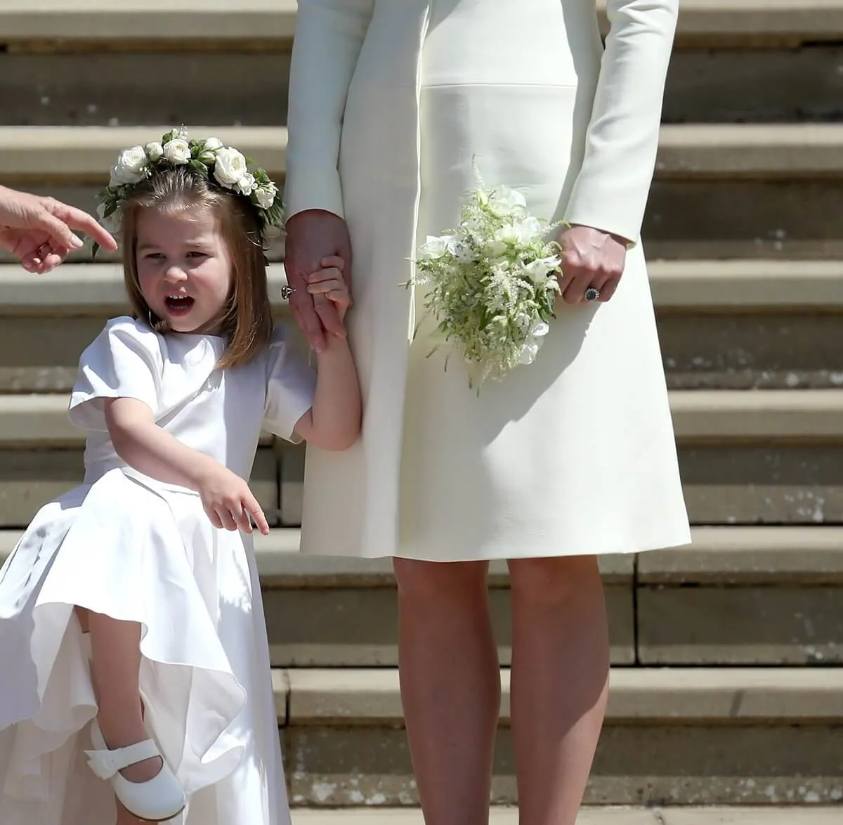 Princess Charlotte holding her mother, Kate Middleton's hand outside St. George's Chapel after Prince Harry and Meghan Markle wedding