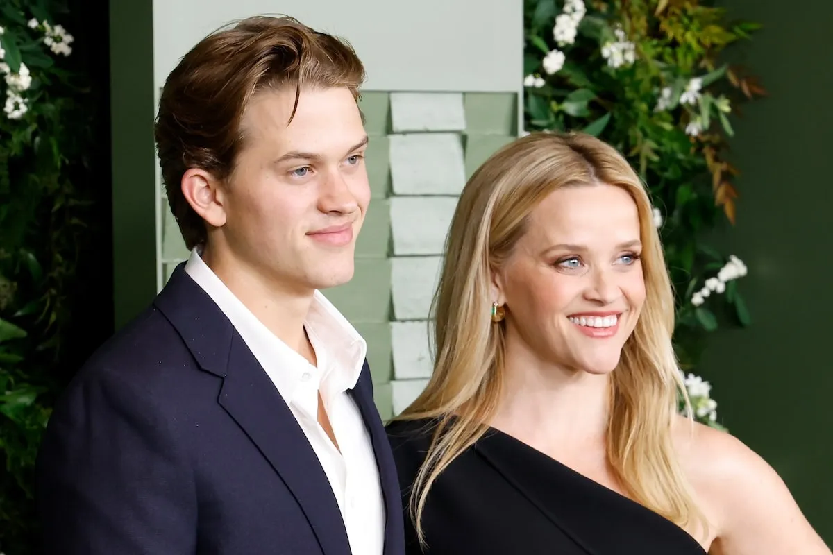 Deacon Phillippe stands next to his mom Reese Witherspoon as they smile on the green carpet at the WSJ Innovator Awards