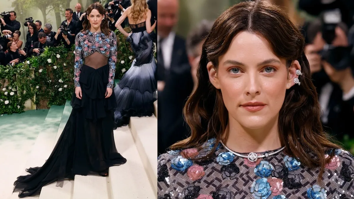 Wearing a black, pink, and blue Chanel dress, Riley Keough poses on the white carpet at the 2024 Met Gala