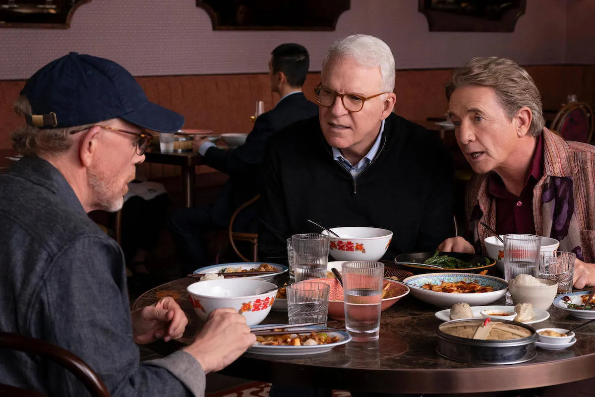 Ron Howard, Steve Martin, and Martin Short sit at a table in 'Only Murders in the Building'