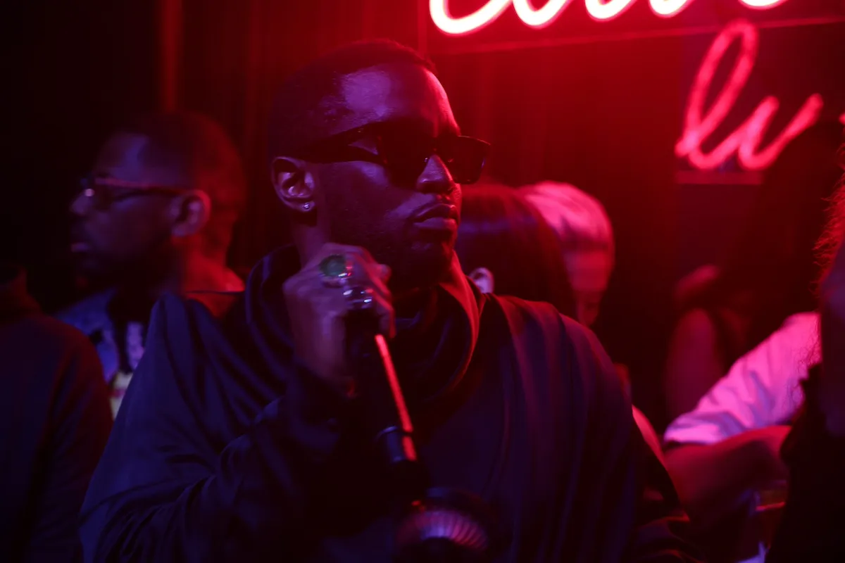 Sean Diddy Combs wearing sunglasses and holding a microphone