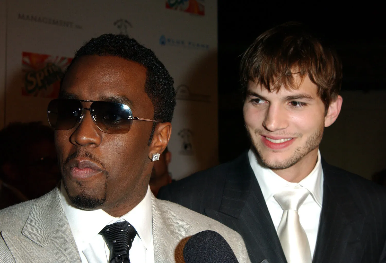 Sean 'Diddy' Combs and Ashton Kutcher standing next to each other at an afterparty in 2003