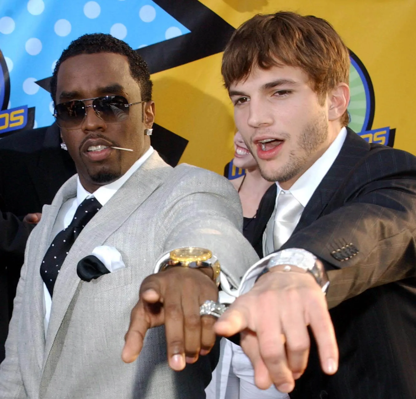 Sean 'Diddy' Combs and Ashton Kutcher pointing at the camera at the MTV Movie Awards in 2003