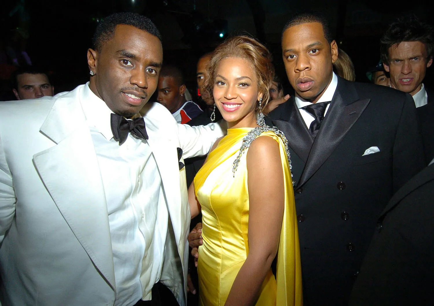 Sean 'Diddy' Combs, Beyoncé, and Jay-Z posing together in 2004