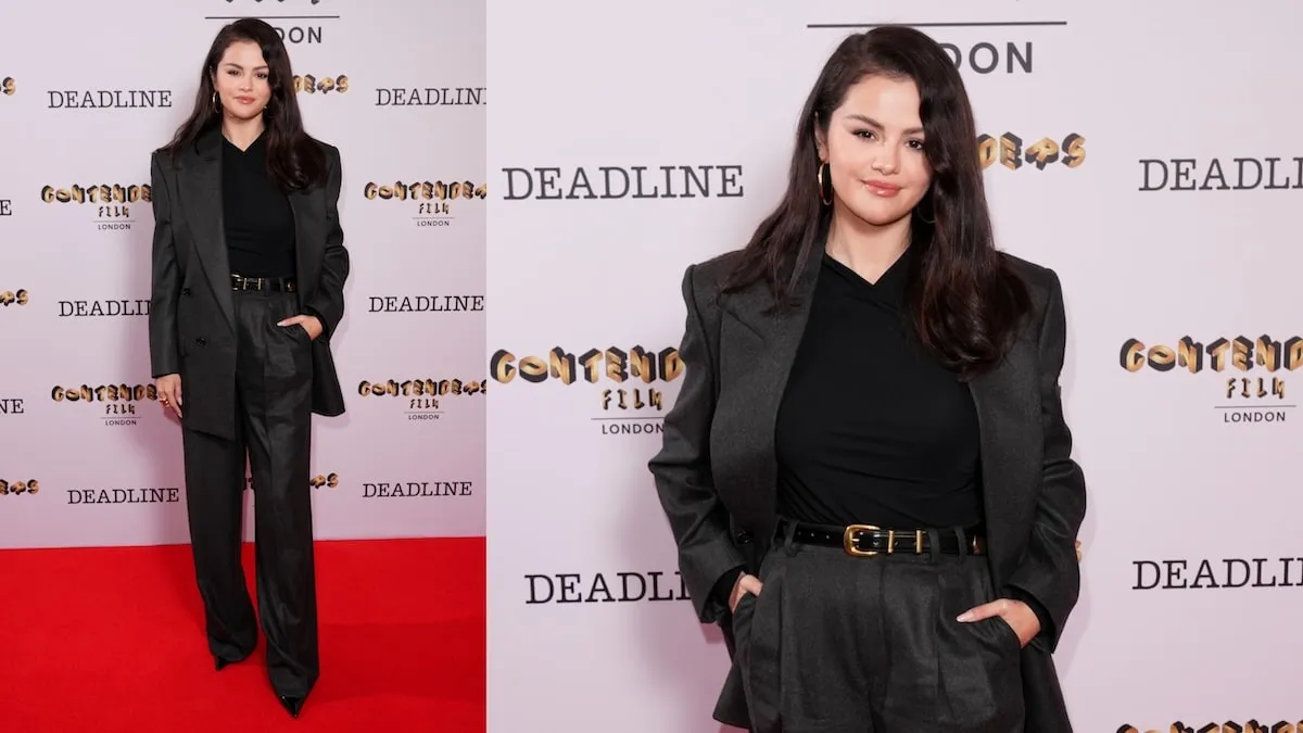 Wearing a charcoal gray suit, Selena Gomez stands in front of cameras at Deadline Contenders Film: London 2024